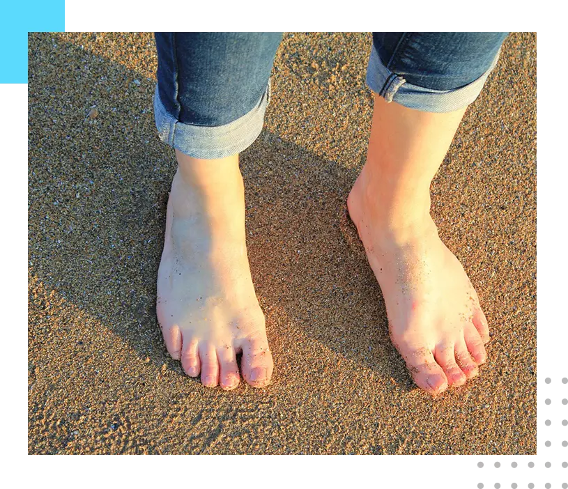 A person standing on top of a sandy beach.