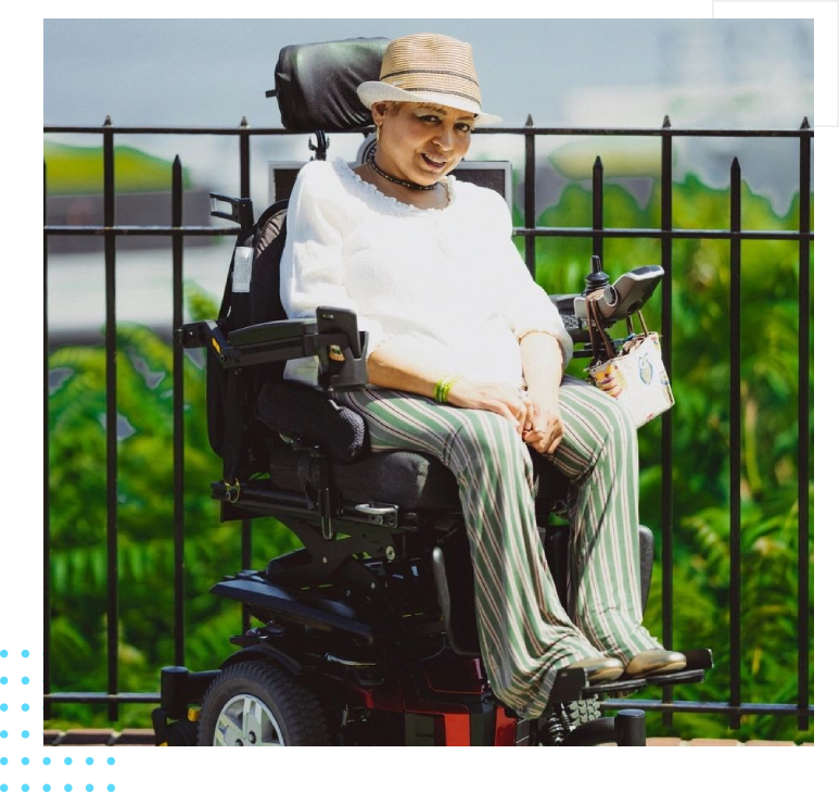 A man in a wheelchair with a hat on.